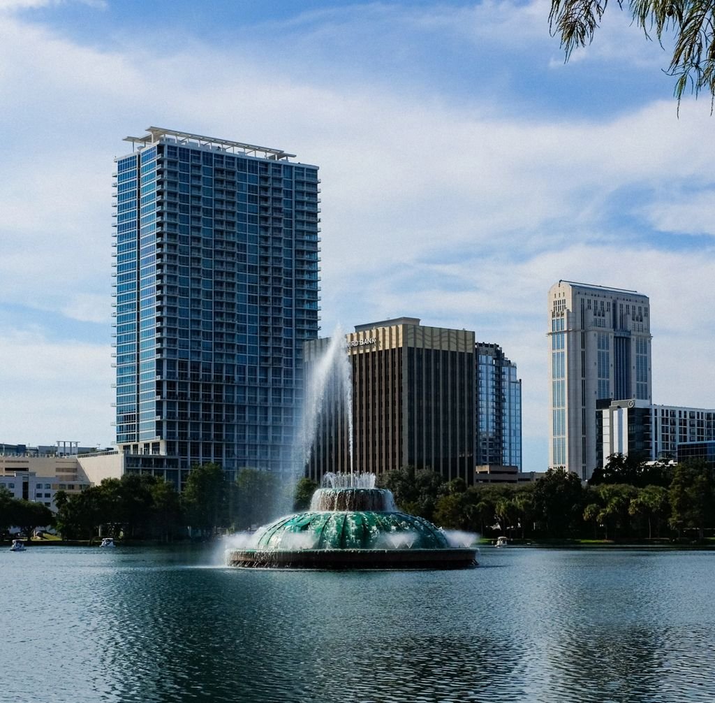 Skyline of Orlando featuring the famous Lake Eola fountain and modern skyscrapers.
